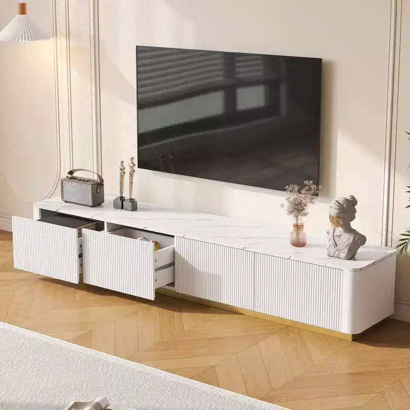 Meuble TV cannelé pour téléviseurs jusqu'à 85 pouces, console média avec plateau en faux marbre et 4 tiroirs, meuble de divertissement avec base dorée